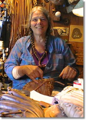 Photo of Fran Fleet in her shop. Fran does baseball glove repair and is the developer of Glove Stuff® baseball glove conditioner